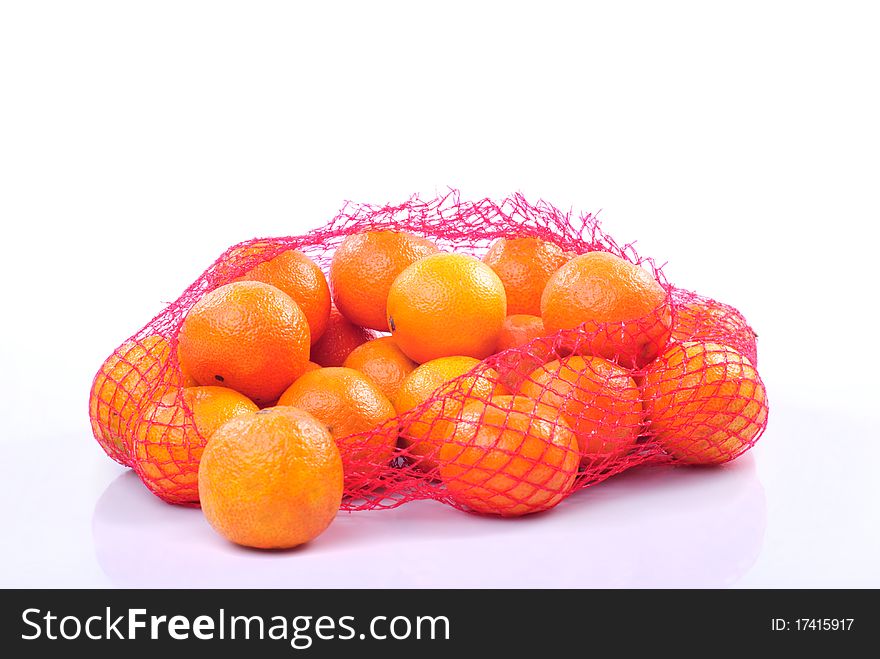Hand holding a bag of tangerines isolated on white background. Hand holding a bag of tangerines isolated on white background.