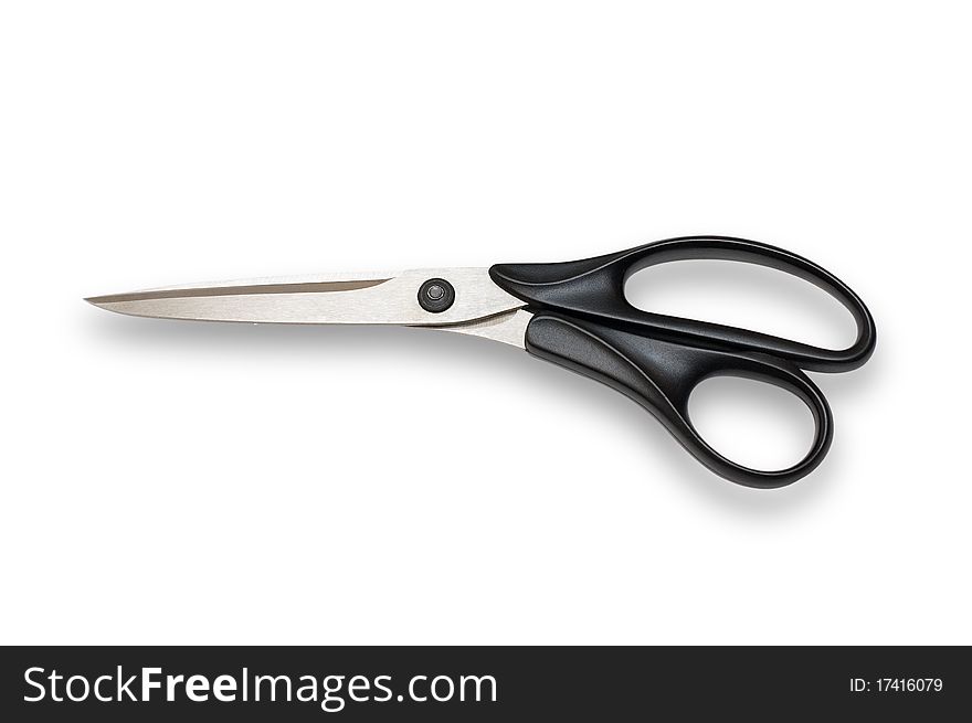 Tailor's scissors from stainless steel with black plastic handles. On a white background