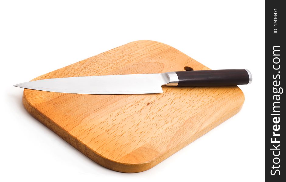 Kitchen knife lying on a cutting board, white background