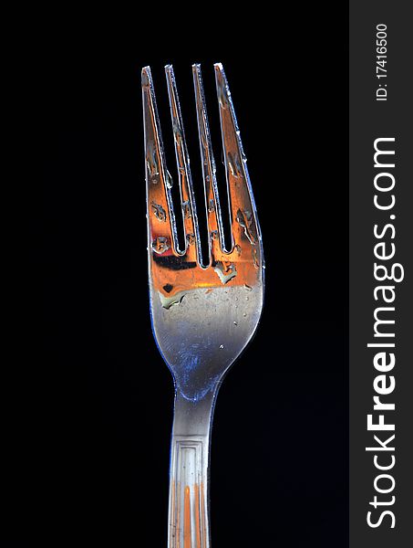 Water drops on fork macro isolated on black background. Water drops on fork macro isolated on black background.