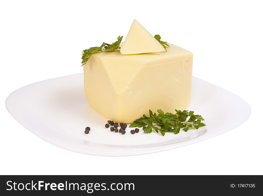 Cheddar cheese with parsley and pepper on a plate isolated over white background with clipping path