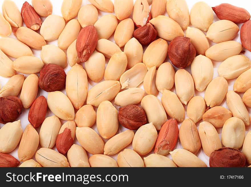 Background of peanuts and hazelnuts on white. Background of peanuts and hazelnuts on white