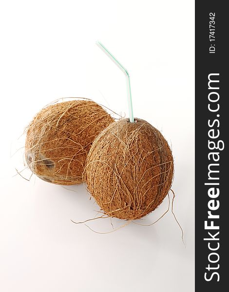 Two coconuts with a straw