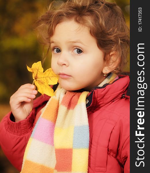 Outdoor portrait little girl with leaf