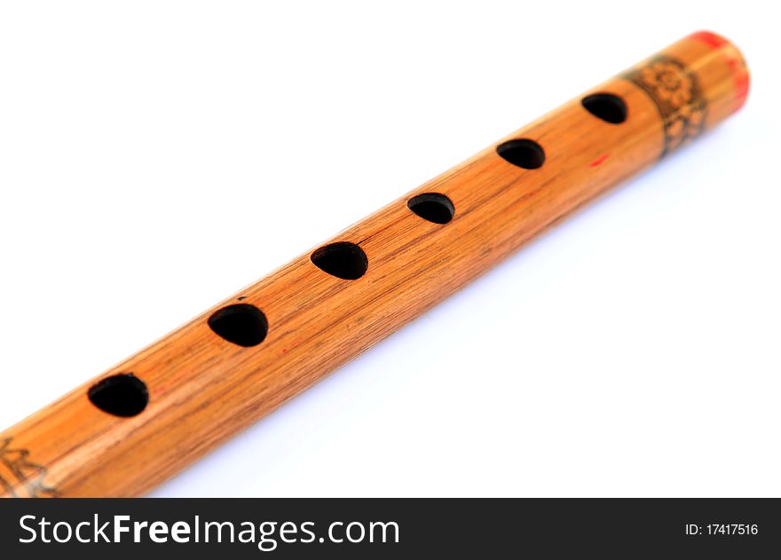 Closeup shot of wooden flute holes over white background. Closeup shot of wooden flute holes over white background.