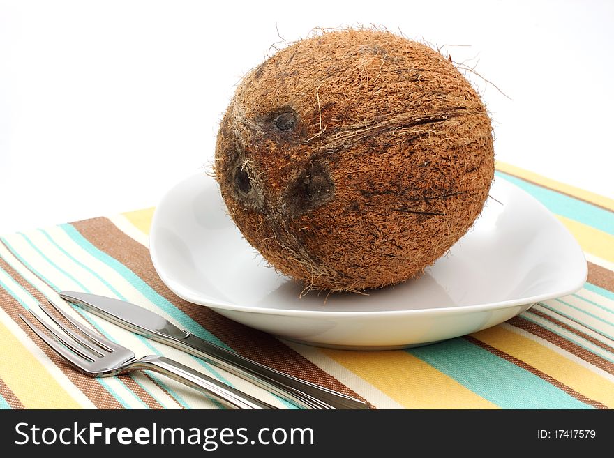 Closed coconut on a plate