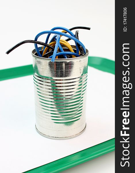 Roll of wire into a metal tin. Roll of wire into a metal tin