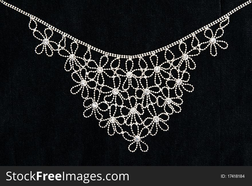 Necklace with sparkling stones on dark fabric