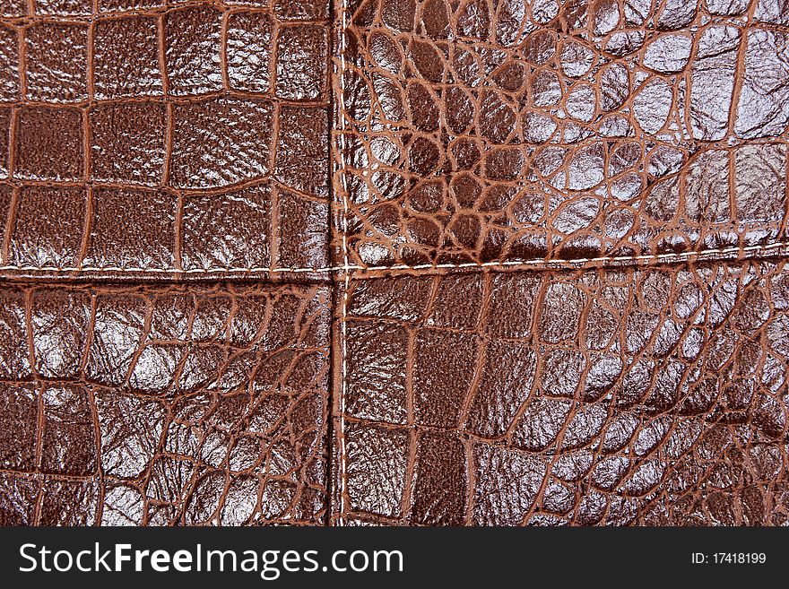 Background of brown leather with a seam