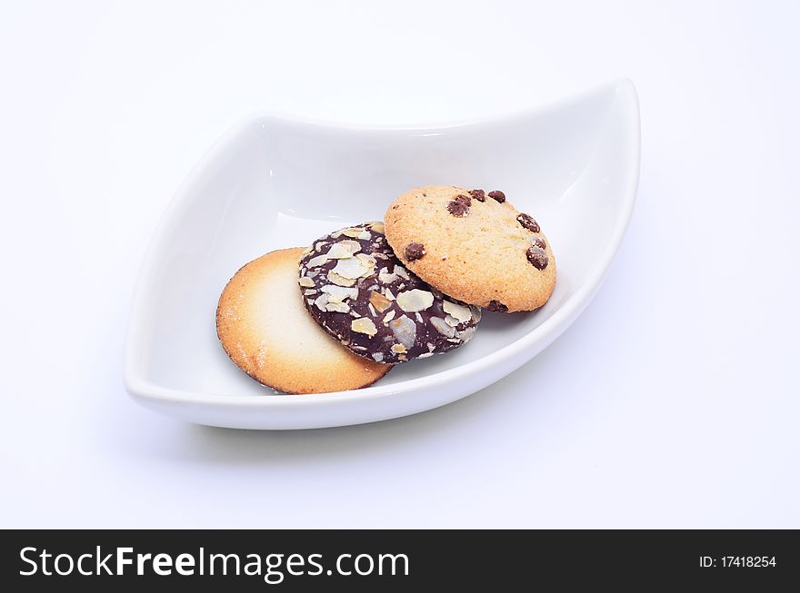 Delicious cookies and biscuits on white plate and white background