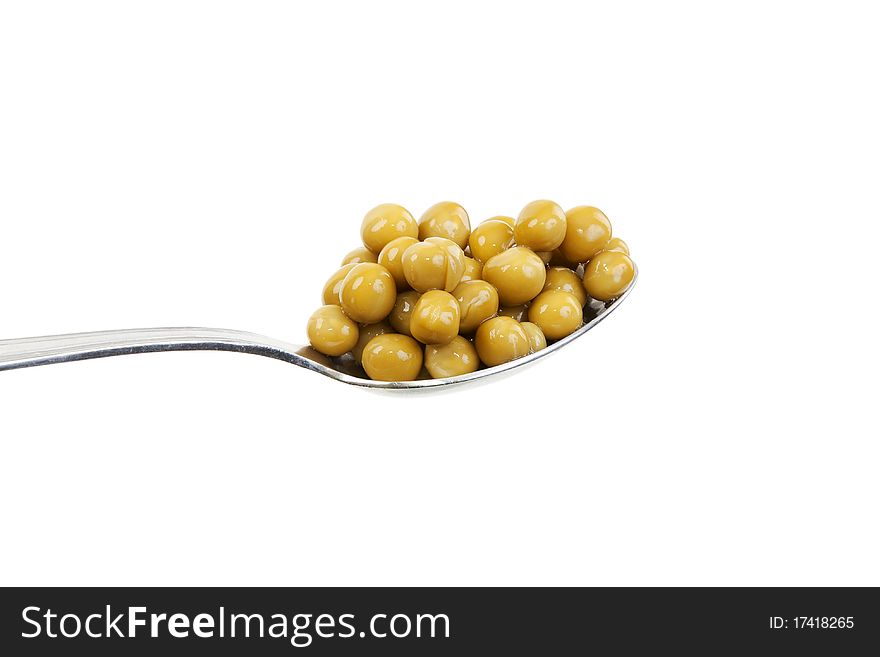 Spoon with green peas on a white background