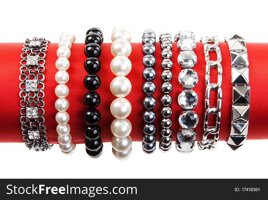 Women's bracelets on the red hat on a white background