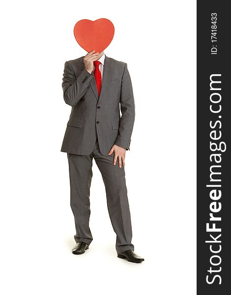 Man in gray suit and tie keeps in hand decorative red heart