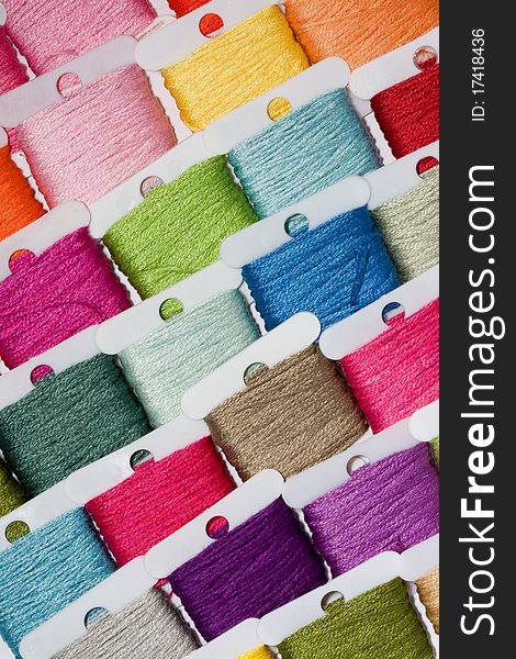A selection of brightly coloured cotton threads on bobbins. A selection of brightly coloured cotton threads on bobbins