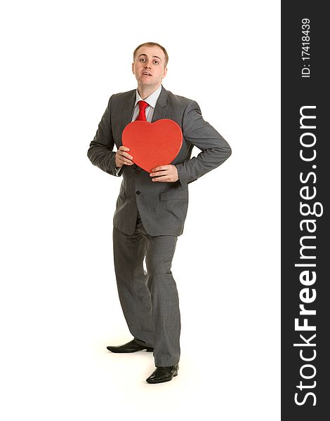 Man in gray suit and tie keeps in hand decorative red heart