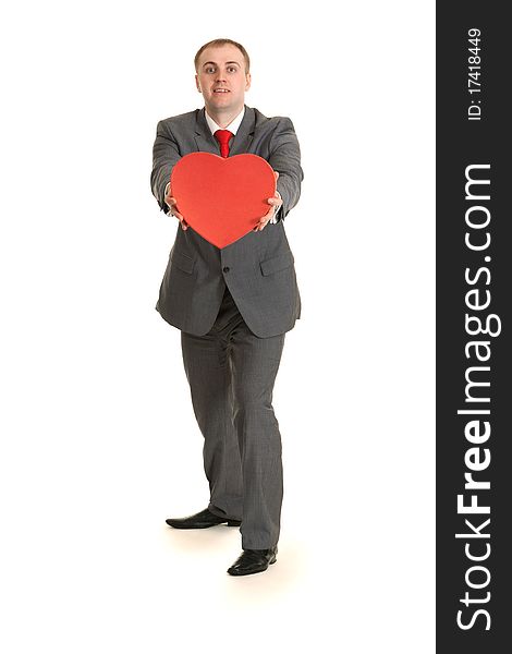 Man in gray suit and tie keeps in hand decorative red heart