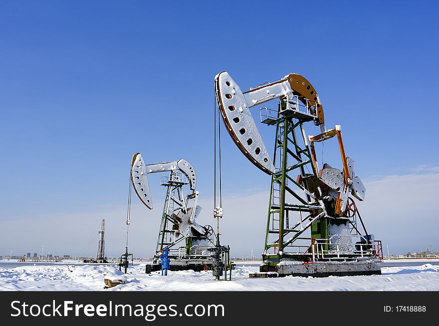 Cold winter, oil producing equipment is covered with snow. Cold winter, oil producing equipment is covered with snow