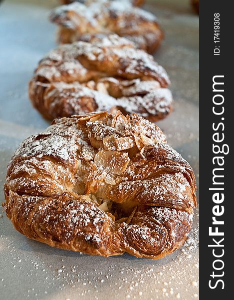 Flaky almond croissant with powdered sugar