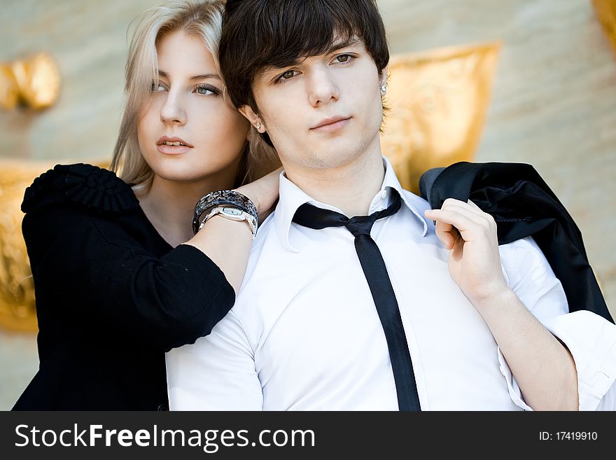 Couple - girl and guy near the wall