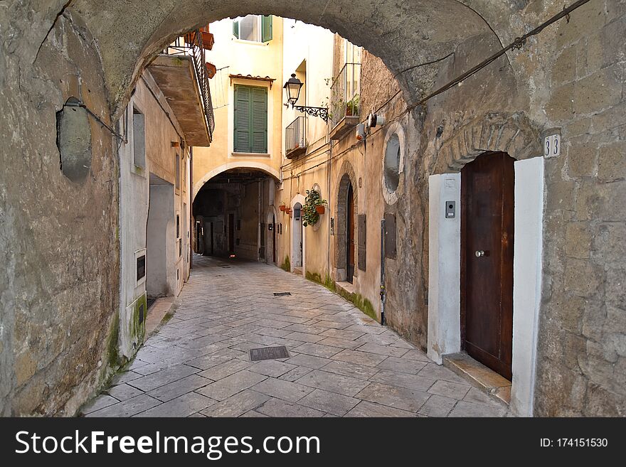 Sant`Agata de `Goti, Italy, 02/29/2020. A narrow street between old houses of a medieval village. Sant`Agata de `Goti, Italy, 02/29/2020. A narrow street between old houses of a medieval village.