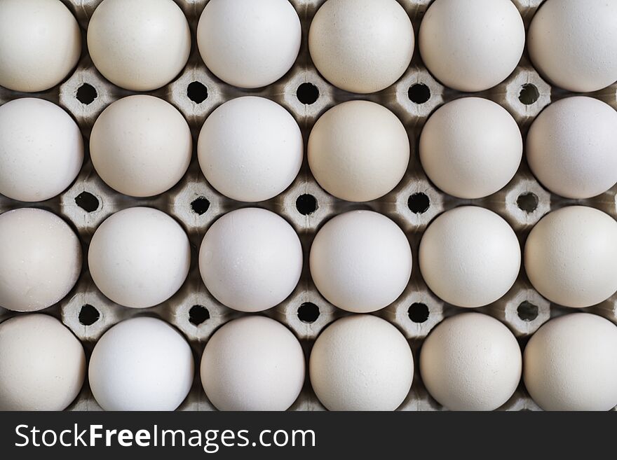 Fresh organic eggs in a carton on a wooden table
