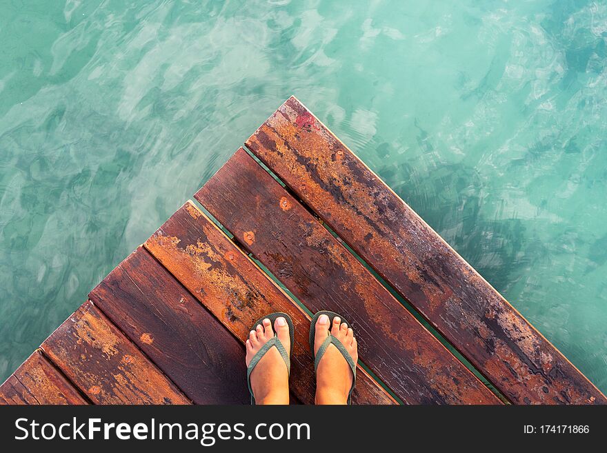 Young woman feets on dock