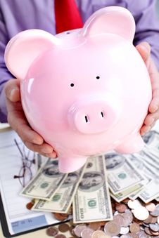 Businessman With A Pig Bank Royalty Free Stock Images