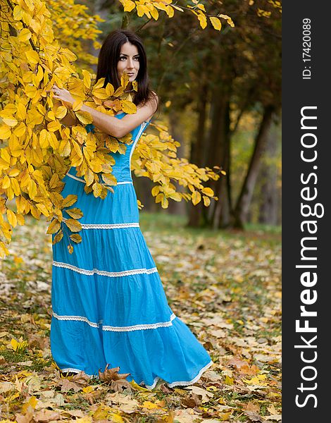 Woman with yellow leaves in autumn