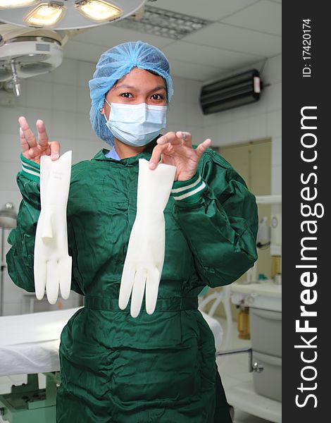 Female nurse showing surgical gloves. Female nurse showing surgical gloves