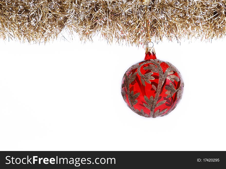 Red gold Christmas ball hangs from decoration isolated on white background. Red gold Christmas ball hangs from decoration isolated on white background