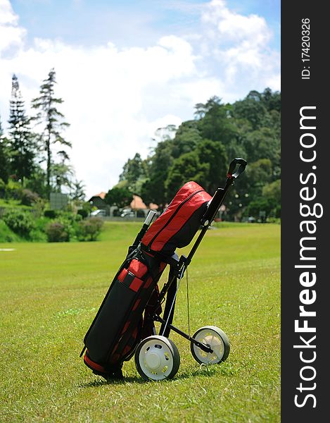 A golf set and trolley in golf course. A golf set and trolley in golf course.