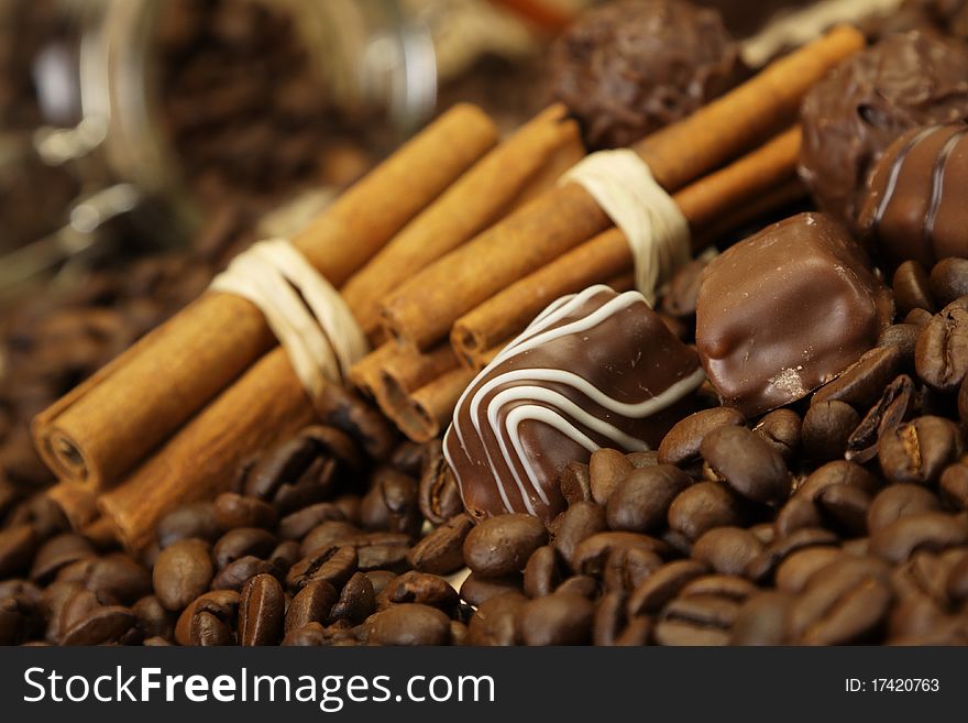 Tasty chocolate with cinnamon on coffee beans background