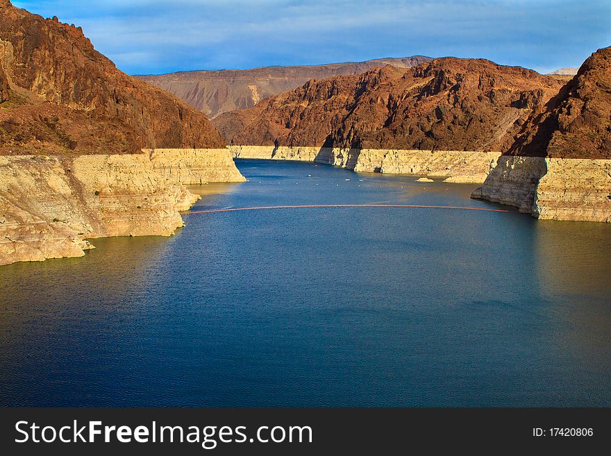 Water level line is shown on the mountains surrounding Lake Mead at Hoover Dam. Water level line is shown on the mountains surrounding Lake Mead at Hoover Dam.