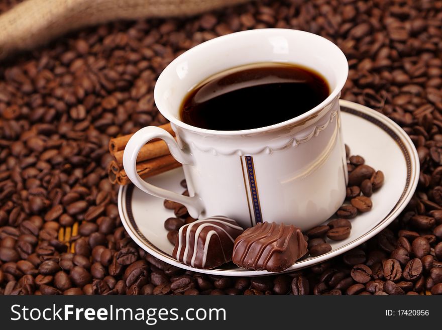 Delicious coffee on coffee beans background. Delicious coffee on coffee beans background