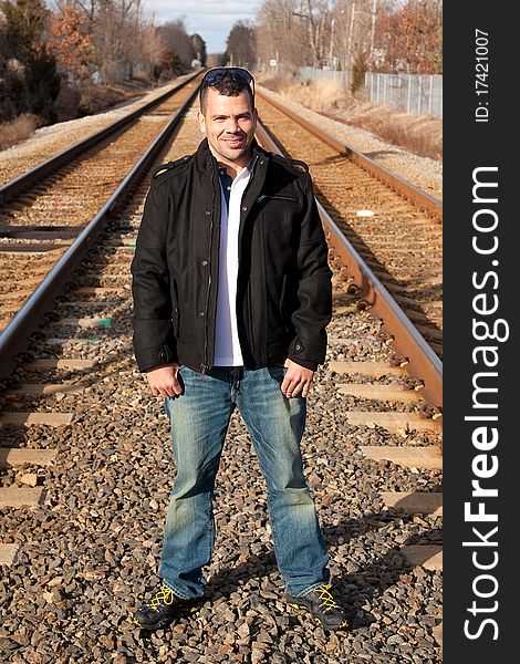 Portrait of a tourist on vacation waiting for his train at the train station.