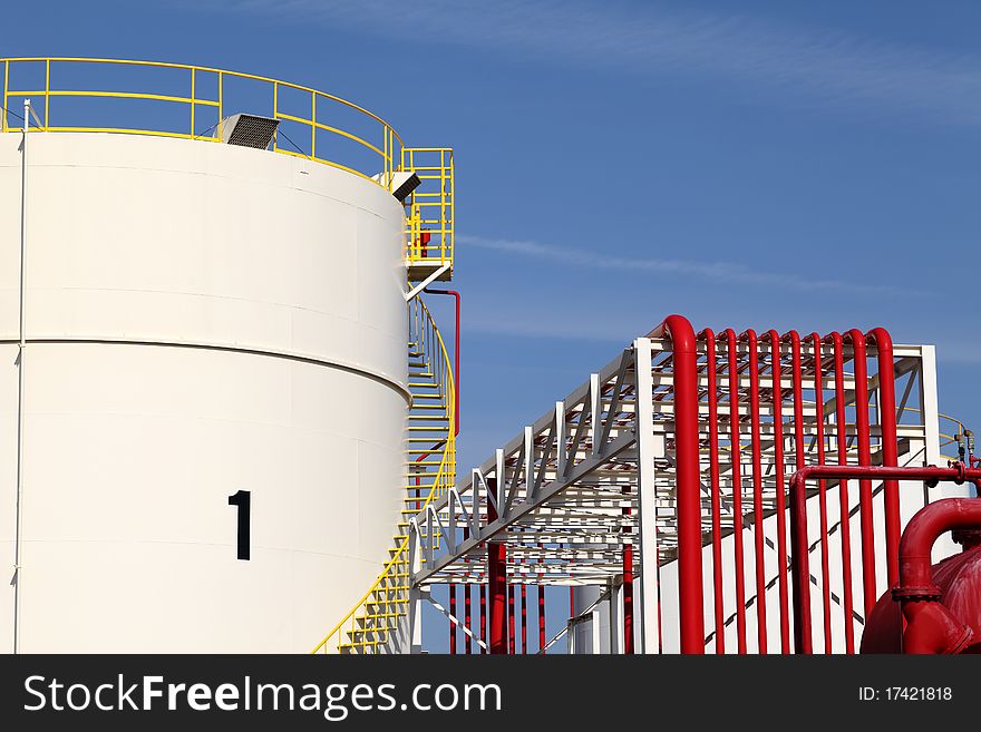 Metal storage tanks and blue sky