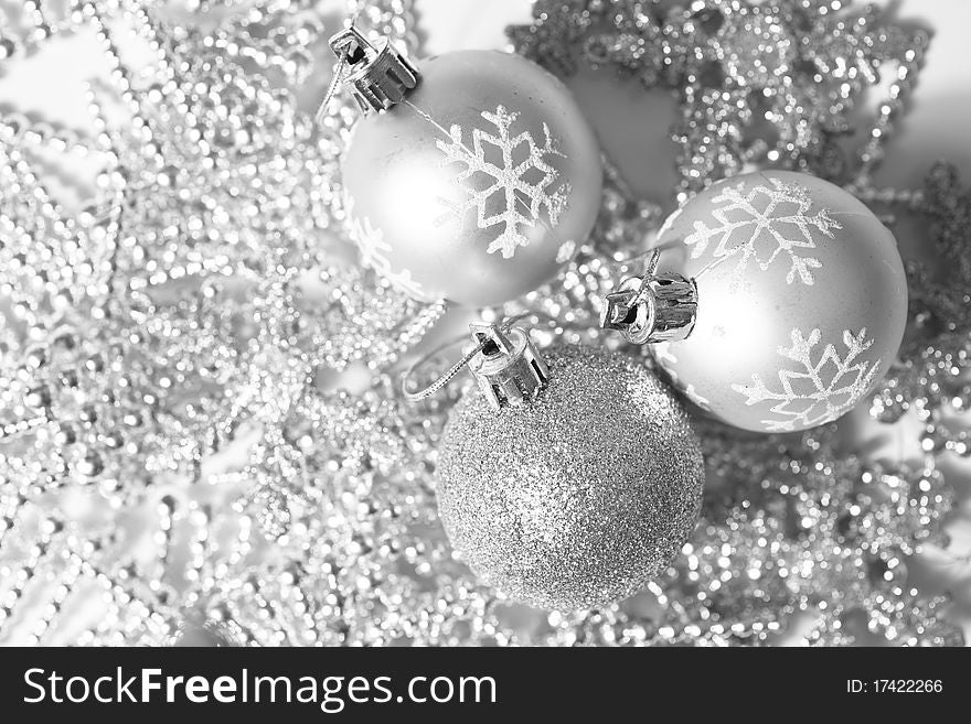 Three decorate silver christmas balls on