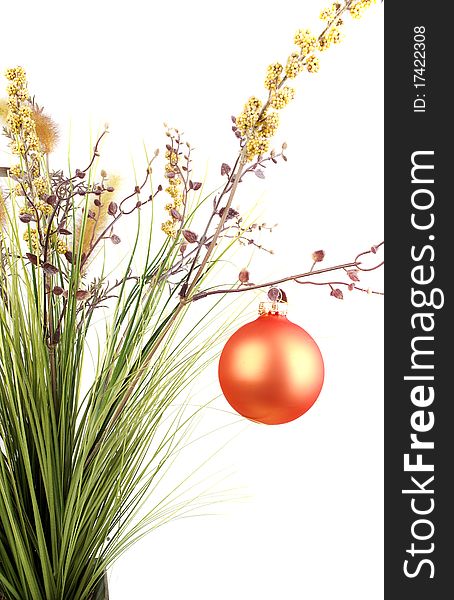 Bunch with artificial grass and blue flowers in metal vase decorated with Christmas orange balls isolated on the white background. Bunch with artificial grass and blue flowers in metal vase decorated with Christmas orange balls isolated on the white background.