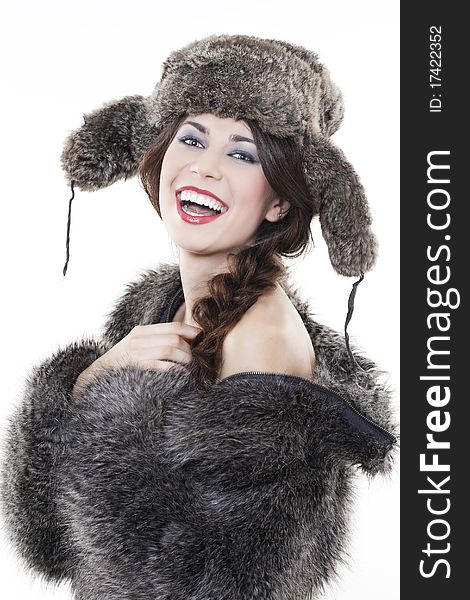 Portrait of young beautiful woman in a fur coat and hat