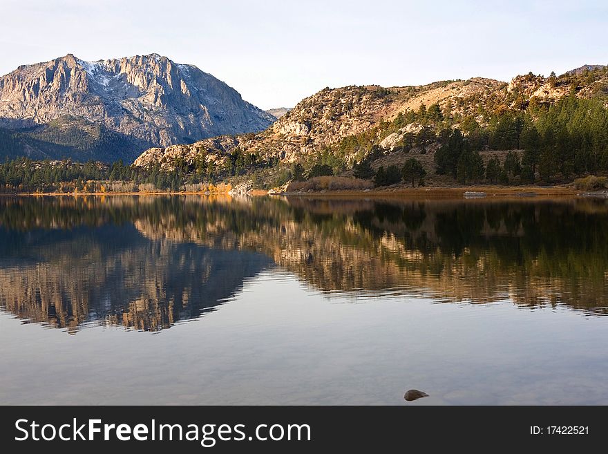 Scenic View Of A Mountain And Lake With Reflection