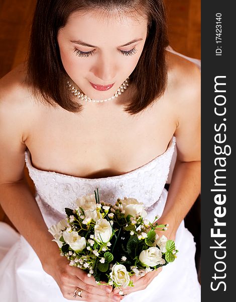 Beauty young woman in wedding dress with flowers