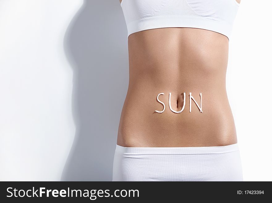 Female abdomen with the words sun. Female abdomen with the words sun