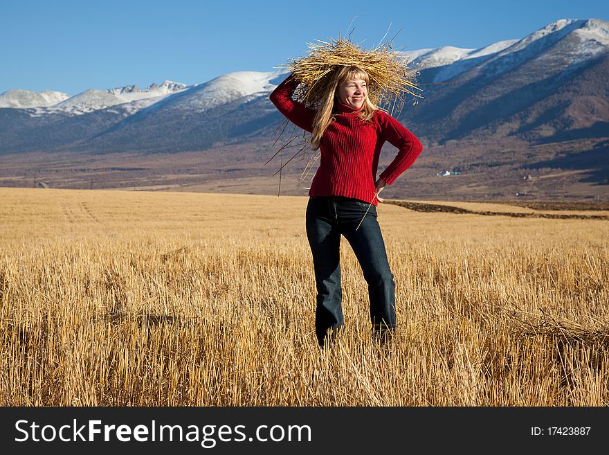 Beauty funny woman with straw on a head. Beauty funny woman with straw on a head