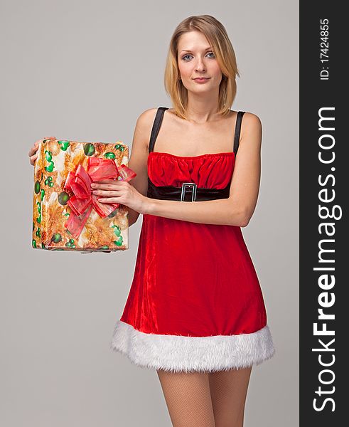 Christmas woman holding gifts on grey background