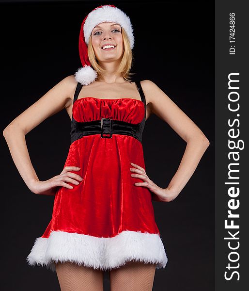 Christmas girl in santa hat on black background. Christmas girl in santa hat on black background