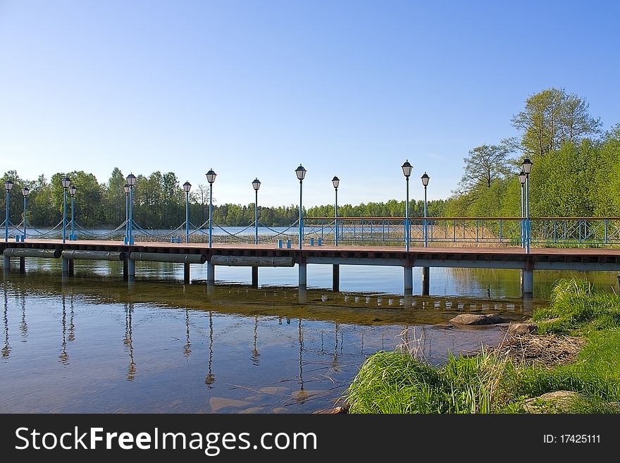 Wooden pier with lanterns on the lake Valdai, Russia. Wooden pier with lanterns on the lake Valdai, Russia.