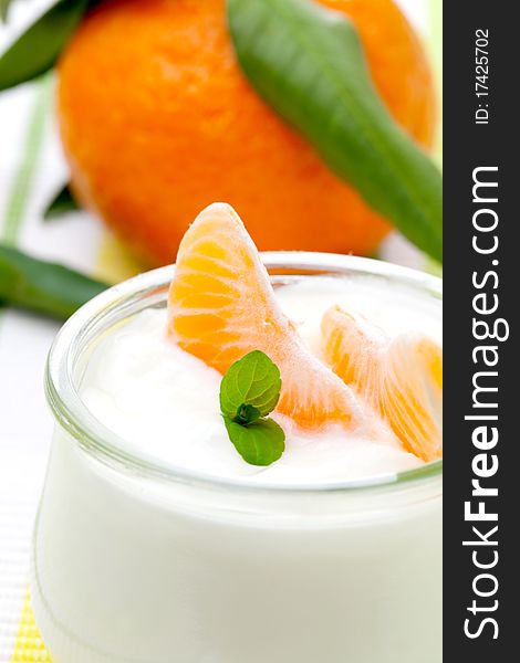 Fresh pure yogurt with mandarin closeup. Fresh pure yogurt with mandarin closeup