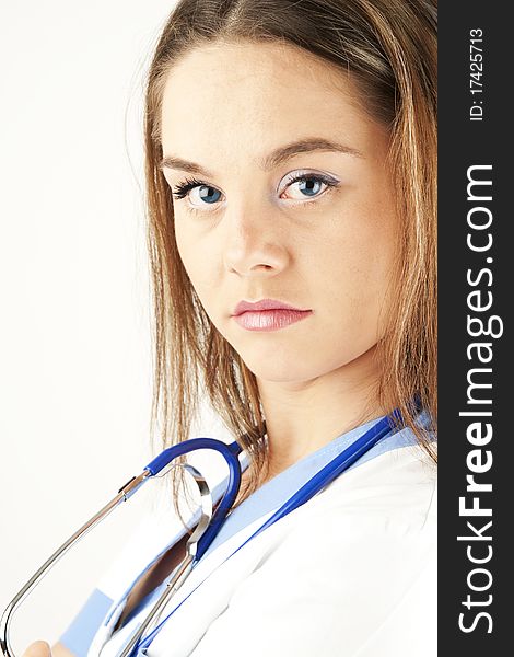 Young woman doctor or nurse holding wearing white and blue scrubs. Young woman doctor or nurse holding wearing white and blue scrubs