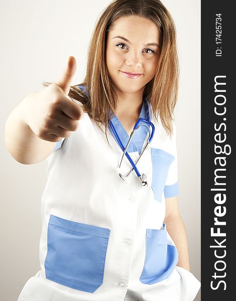 Young woman doctor or nurse holding wearing white and blue scrubs. Young woman doctor or nurse holding wearing white and blue scrubs