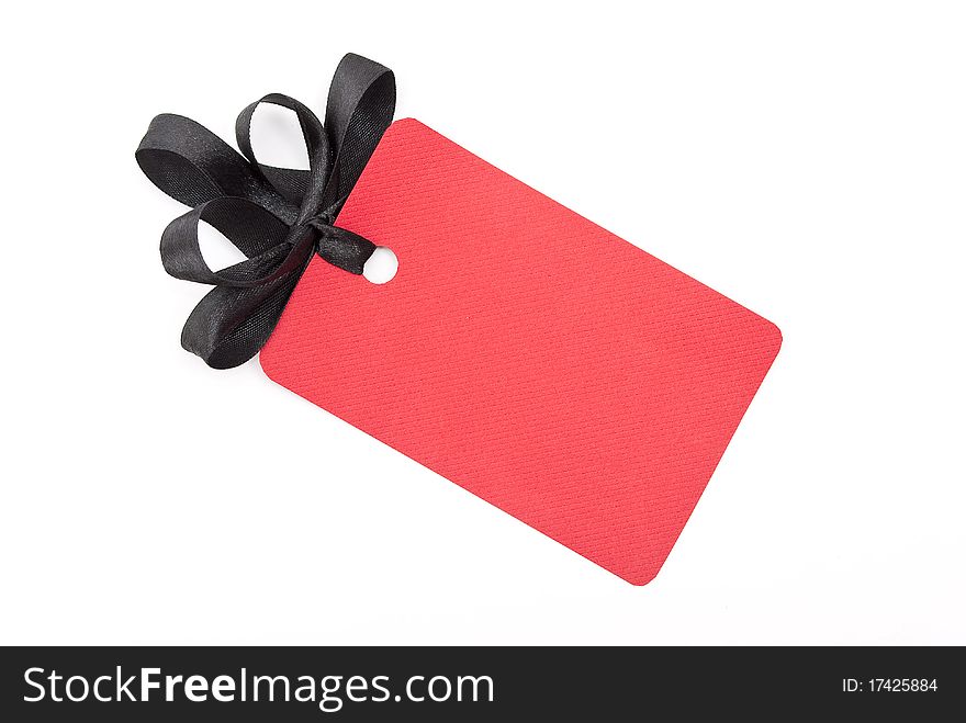 Red gift tag with black bow on white